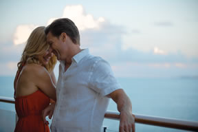 Couple on balcony of a cruise