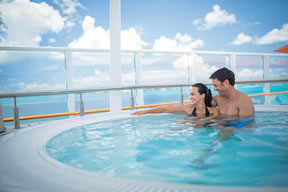 Couple relaxing in hot tub on the NCL Breakaway