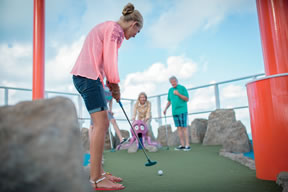 Family playing mini golf on the Norwegian Breakaway